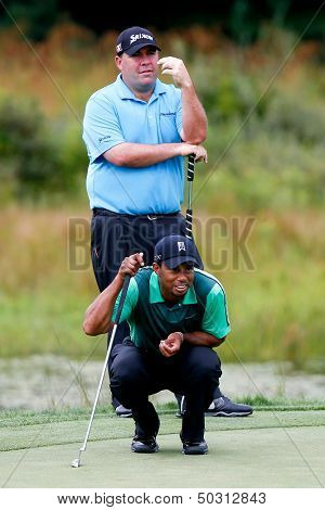 NORTON, MA-SEP 1: Tiger Woods (bottom) reads the green as Kevin Stadler stands during the third round at the Deutsche Bank Championship at TPC Boston on September 1, 2013 in Norton, Massachusetts. 