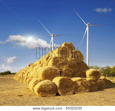 Haystacks on the field. After harvesting. windmill