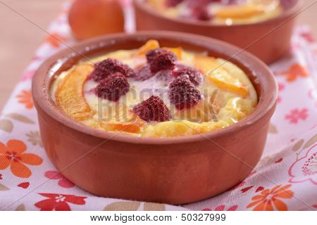 Apricot and raspberry clafoutis in a baking dish
