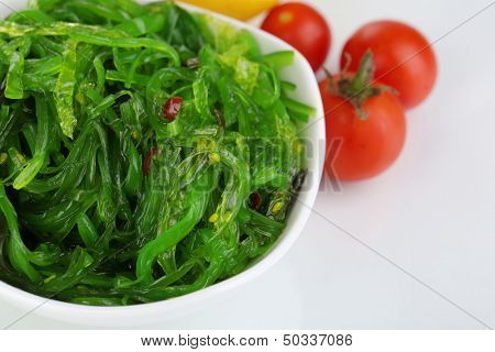 Sea kale in bowl close-up isolated on white