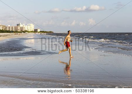 Teenager Enjoys Jogging Along The Beach