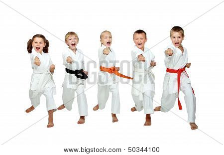 In the kimono little kids beat a karate kick arm