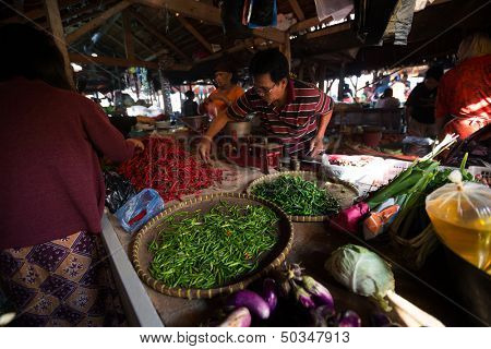 PADANG - AUGUST 25: Traders work at their stalls sell local farm produce at a village market in Padang, Sumatera, Indonesia on August 25, 2013. Agriculture and fishery is an important industry here.