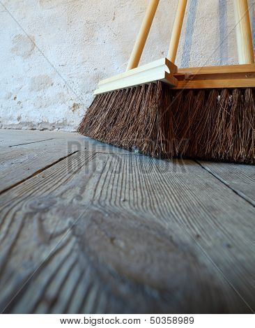 Large Brooms On Wooden Floor Housework