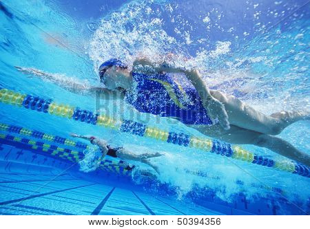 Female professional participants racing in pool