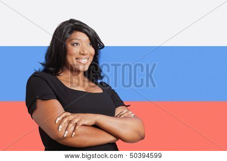 Thoughtful casual mixed race woman over Russian flag