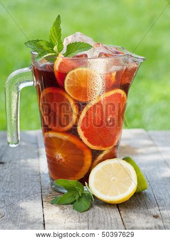 Refreshing fruit sangria (punch) on wood table