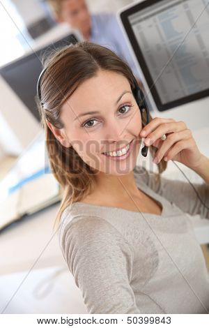 Beautiful smiling teleoperator with headset on 