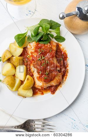 Plate of Cod or Pollack Cooked in Tomato and Thyme Sauce Garnished with Boiled New Potatoes