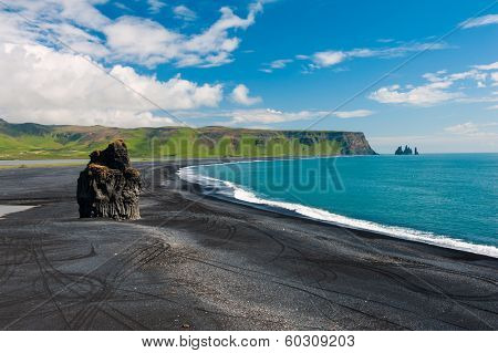 Beautiful rock formation on a black volcanic beach at Cape Dyrholaey, the most southern point of Iceland. 