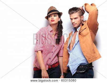 man and woman fashion models looking away and posing in studio