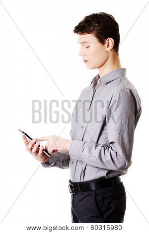 Young businessman using tablet computer isolated on white background
