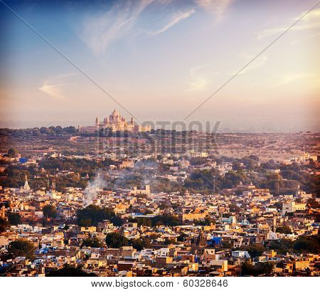 Vintage retro hiptster style photo of aerial view of Jodhpur - the Blue city - with Umaid Bhawan Palace on sunset. View from Mehrangarh Fort.  Jodphur, Rajasthan, India