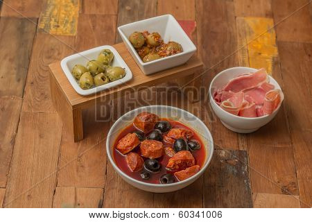 Traditional Spanish Tapas: Chorizo, Ham And Olives