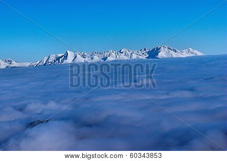 Mountains rise above the clouds