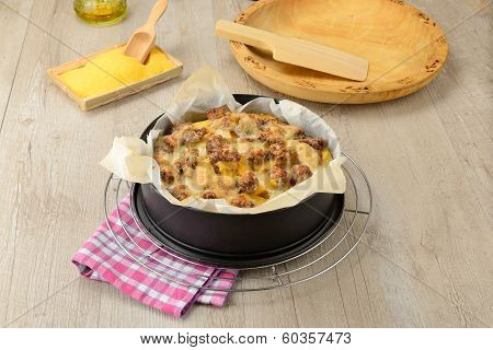 typical Italian dish botched polenta with melted butter and pieces of sausage