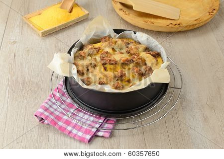 typical Italian dish botched polenta with melted butter and pieces of sausage