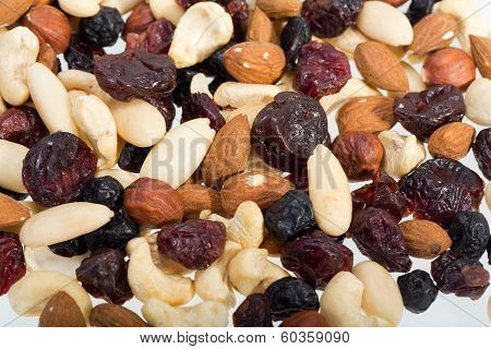 mixed nuts and dried fruits isolated on white background