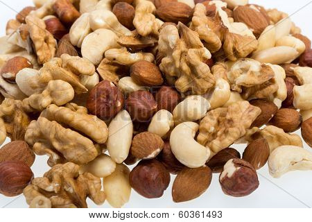 mixed nuts - hazelnuts walnuts cashews pine nuts isolated on white background