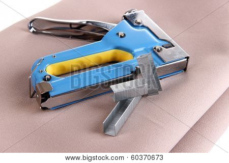 Construction stapler on fabric close up