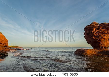 Red Sandstone Rocks At High Tide