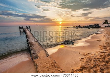 Sunset over the sea at Phu Quoc island in Vietnam. Pier on the foreground