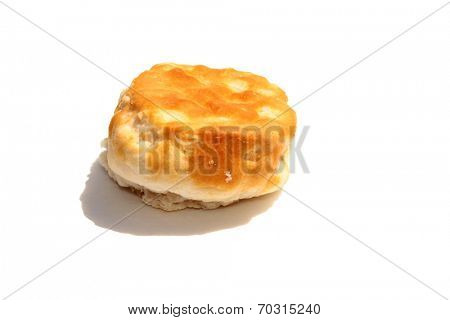 A  Fresh from the Oven Piping Hot Golden Brown Flour Biscuit isolated on white with room for your text. Flour Biscuits are eaten around the world by hungry people, with Fried Chicken, Gravy and more.