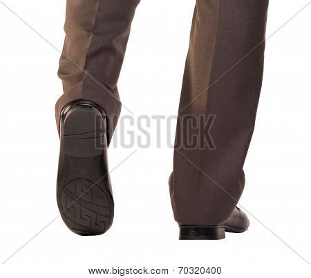 Shoe and leg of a businessman caution step
