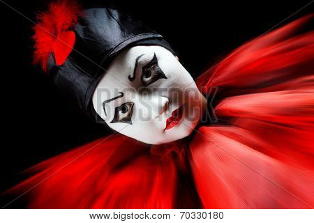 Flashing portrait in red and black of a mime pierrot clown
