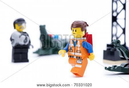Ankara, Turkey - March 15, 2014 : Studio shot of Lego Movie bad cop trying to catch Emmet isolated on white background. 