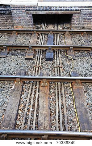 Points rods from signal box under rail track.