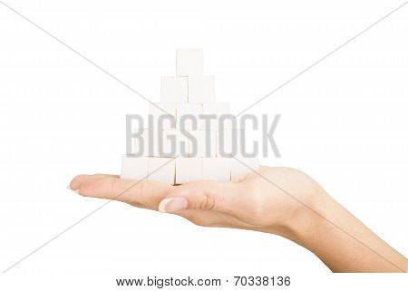 Pyramid Of Lumpy Sugar In The Palm On White Background