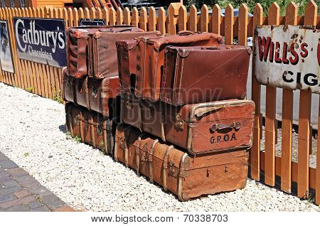 Old leather suitcases on railway platform.