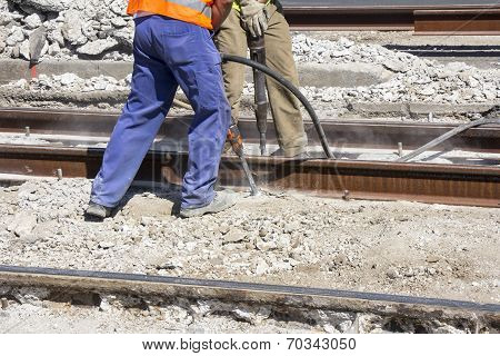 Two Workers With Pneumatic Hammer