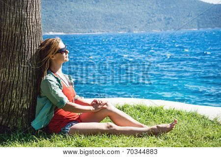 Woman sitting at the beach