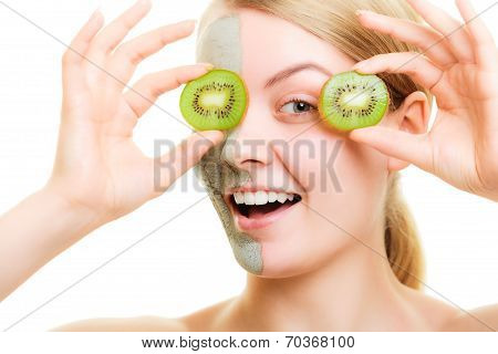 Skin Care. Woman In Clay Mask With Kiwi On Face