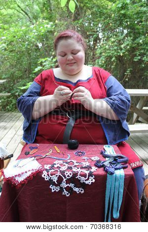 MUSKOGEE, OK - MAY 24: Women show art of lace making, as it was made in the Middle Ages, at the Oklahoma 19th annual Renaissance Festival on May 24, 2014 at the Castle of Muskogee in Muskogee, OK 