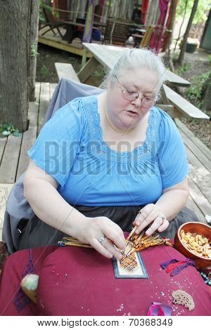 MUSKOGEE, OK - MAY 24: Women show art of lace making, as it was made in the Middle Ages, at the Oklahoma 19th annual Renaissance Festival on May 24, 2014 at the Castle of Muskogee in Muskogee, OK 