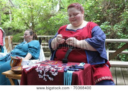 MUSKOGEE, OK - MAY 24: Women show art of lace making, as it was made in the Middle Ages, at the Oklahoma 19th annual Renaissance Festival on May 24, 2014 at the Castle of Muskogee in Muskogee, OK 