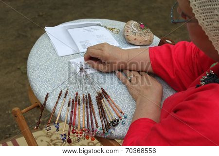 MUSKOGEE, OK - MAY 24: Women show art of lace making, as it was made in the Middle Ages, at the Oklahoma 19th annual Renaissance Festival on May 24, 2014 at the Castle of Muskogee in Muskogee, OK 