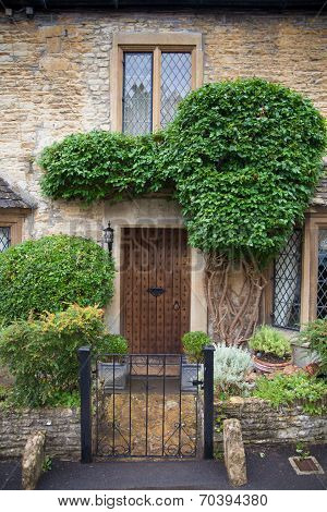 WILTSHIRE, CHIPPENHAM, UK - AUGUST 9, 2014: Castle Combe, unique old English village with luxury hot