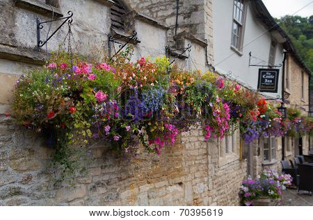 WILTSHIRE, CHIPPENHAM, UK - AUGUST 9, 2014: Castle Combe, unique old English village with luxury hot
