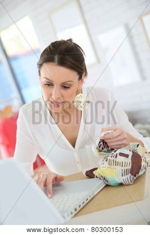 Beautiful shopgirl working in clothing store