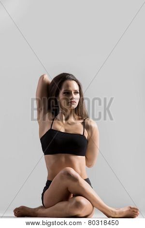 Athletic Yogi Girl In Sportswear Practices Yoga Asana, Gomukhasana