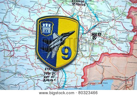 Illustrative editorial.Chevron of Ukrainian air force. 9 Aviation brigade.Estern Ukraine map with site MH-17 flight crush as background. At January 10,2015 in Kiev, Ukraine