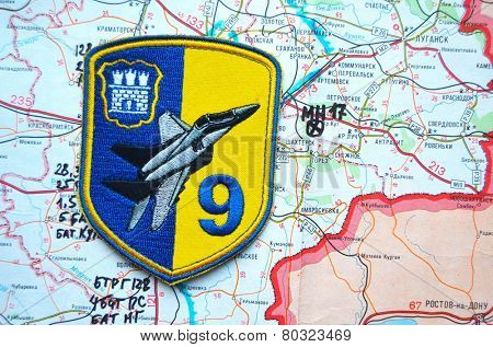 Illustrative editorial.Chevron of Ukrainian air force. 9 Aviation brigade.Estern Ukraine map with site MH-17 flight crush as background. At January 10,2015 in Kiev, Ukraine