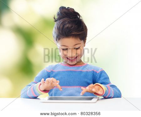 education, children, technology and people concept - happy little girl with tablet pc computer over green background