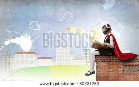 Girl of school age in super hero costume
