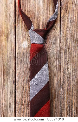 Stripped tie on wooden planks background