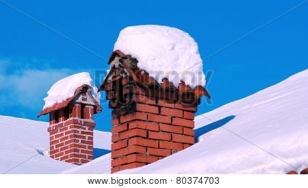Rooftop Chimneys Under Snow